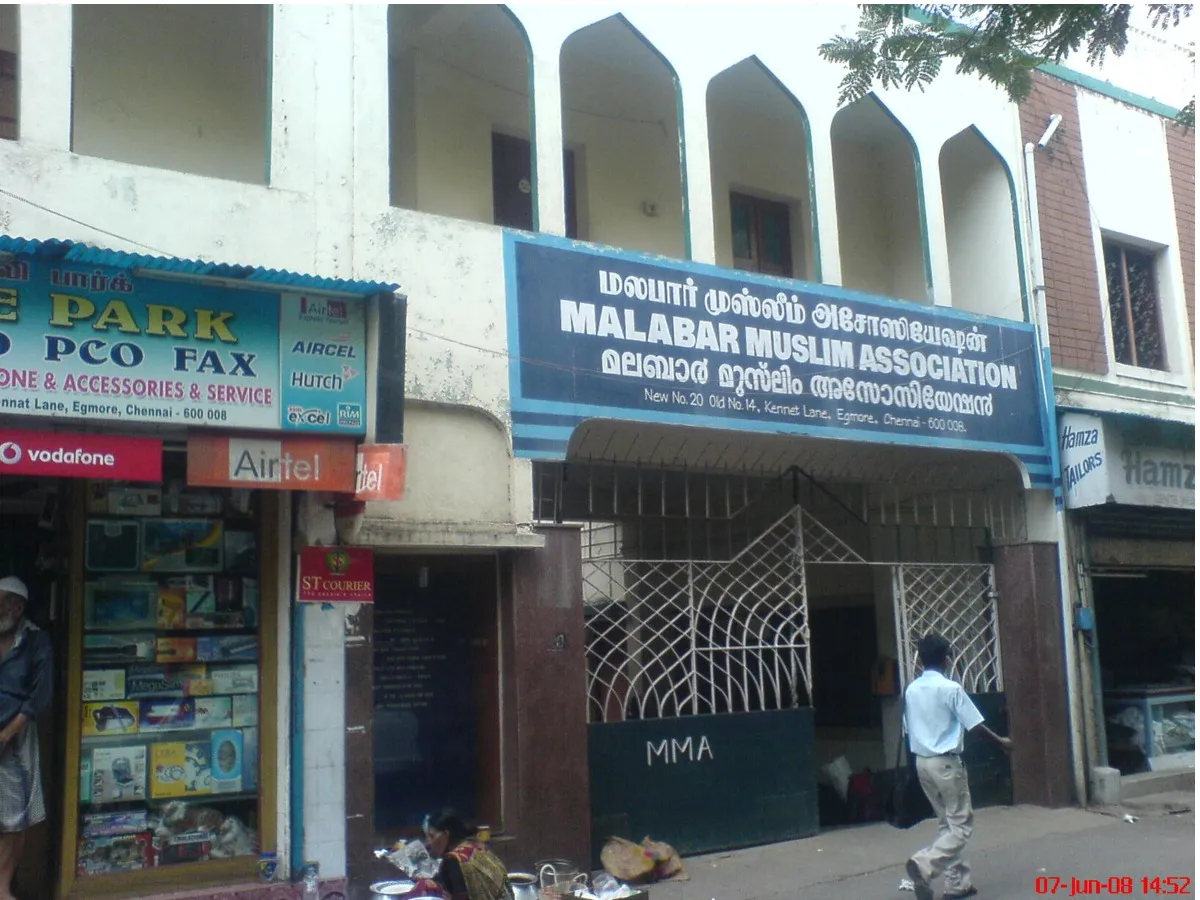 The Malabar Muslim Association signboard above the entrance on Kennet Lane, lettered in Tamil, Malayalam and English, with the full postal address beneath.