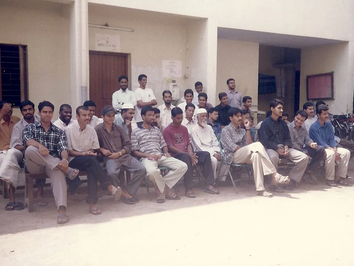 Around thirty residents seated outside the hostel block on Kennet Lane, in the years before the association's alumni scattered.